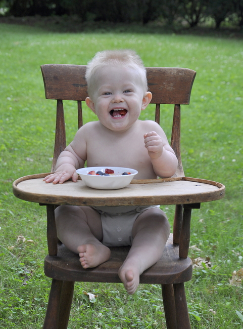 baby laughing in vintage high chair