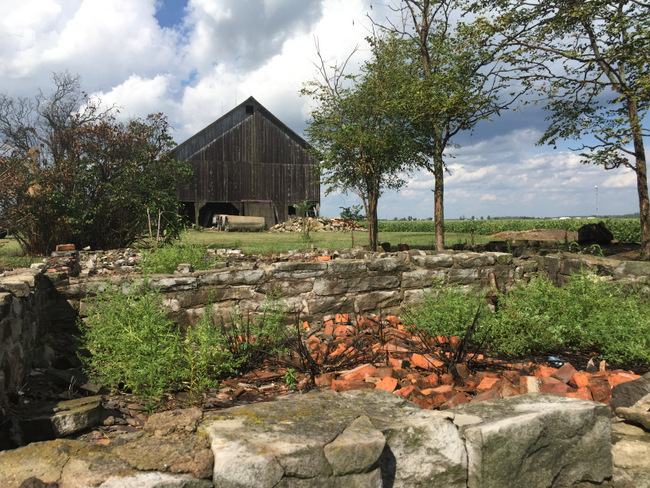 The foundation of the old farmhouse and the original barn.